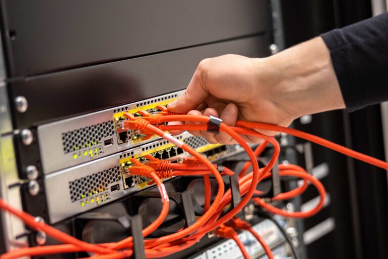 close-up-of-male-technician-plugging-network-cable-2023-11-27-05-07-43-utc (2)